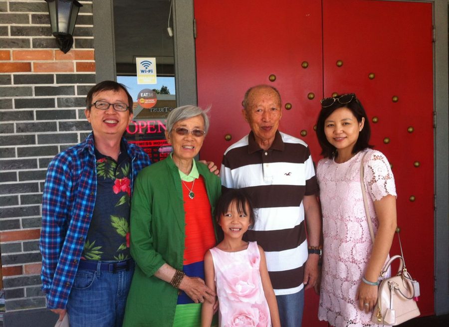 Michelle as a child with her parents and grandparents outside a restaurant